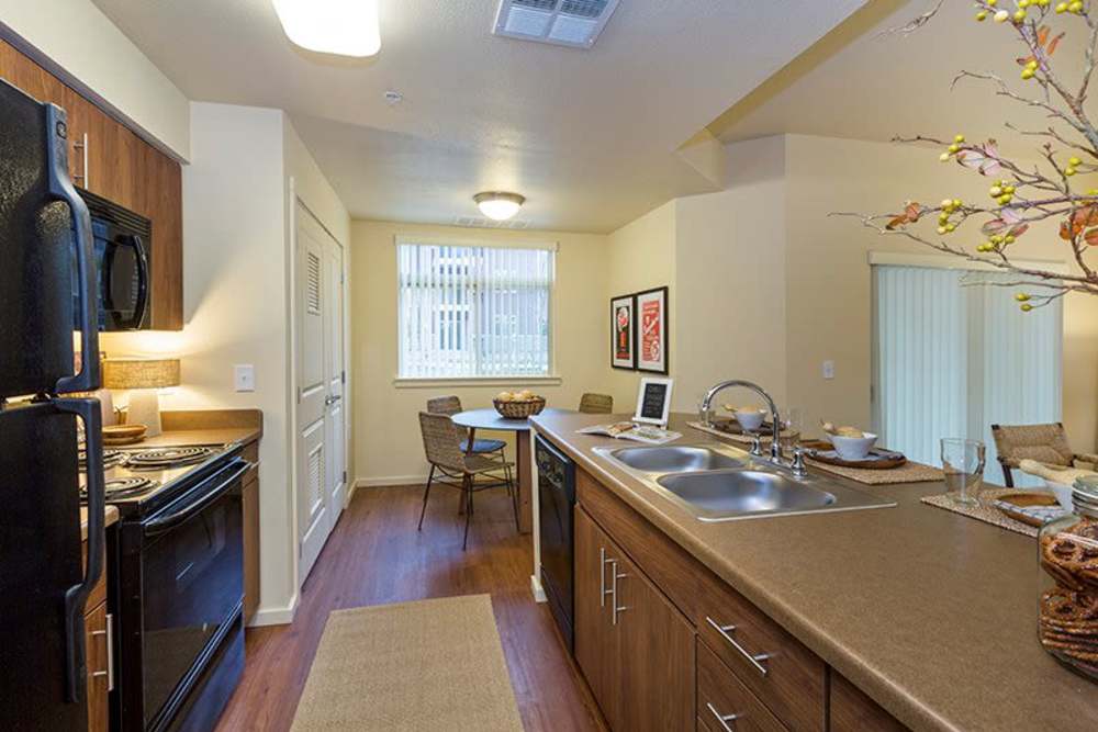 Kitchen with black appliances at Copper Trail in Olympia, Washington