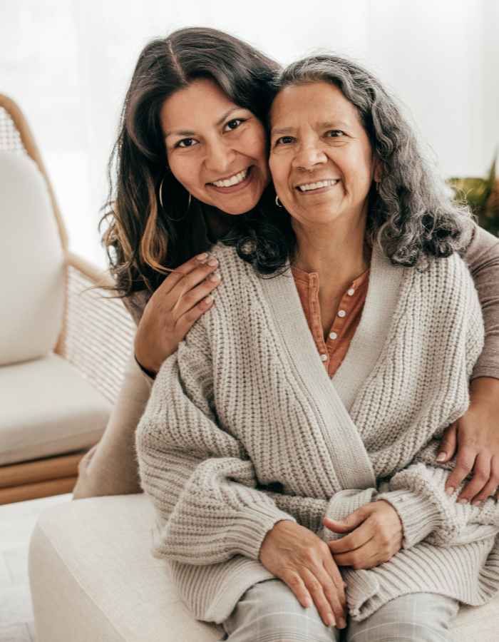 resident receiving a hug from a lady at Clearwater at The Heights in Houston, Texas