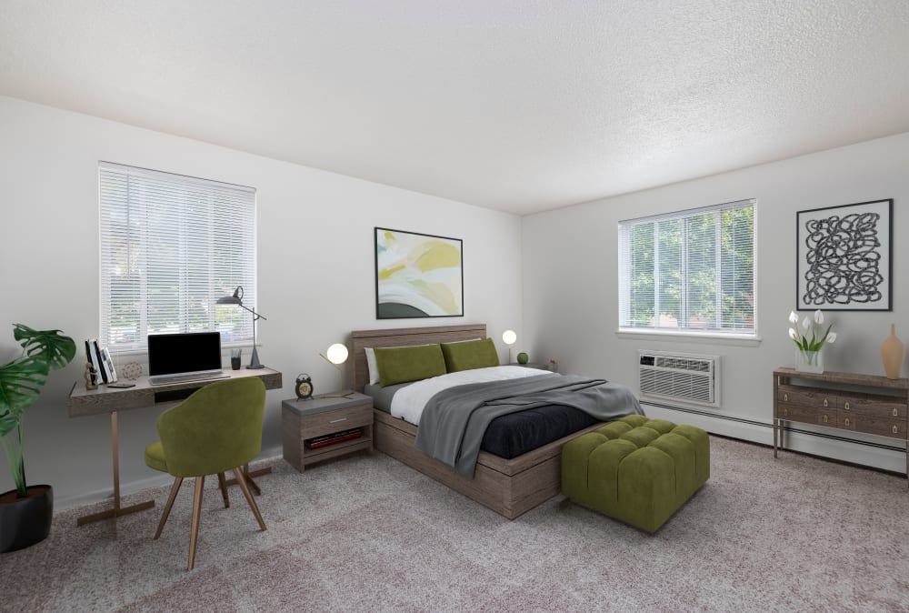 Spacious bedroom with wall to wall carpeting at Perinton Manor Apartments in Fairport, New York