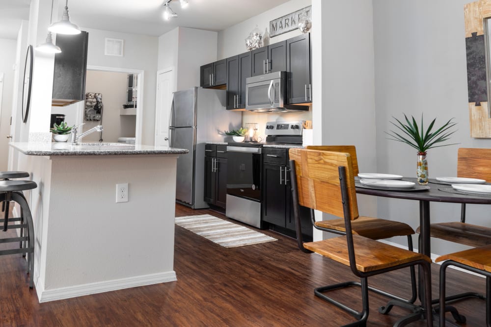 Bar seating at the kitchen island in a model home at Carrington Oaks in Buda, Texas