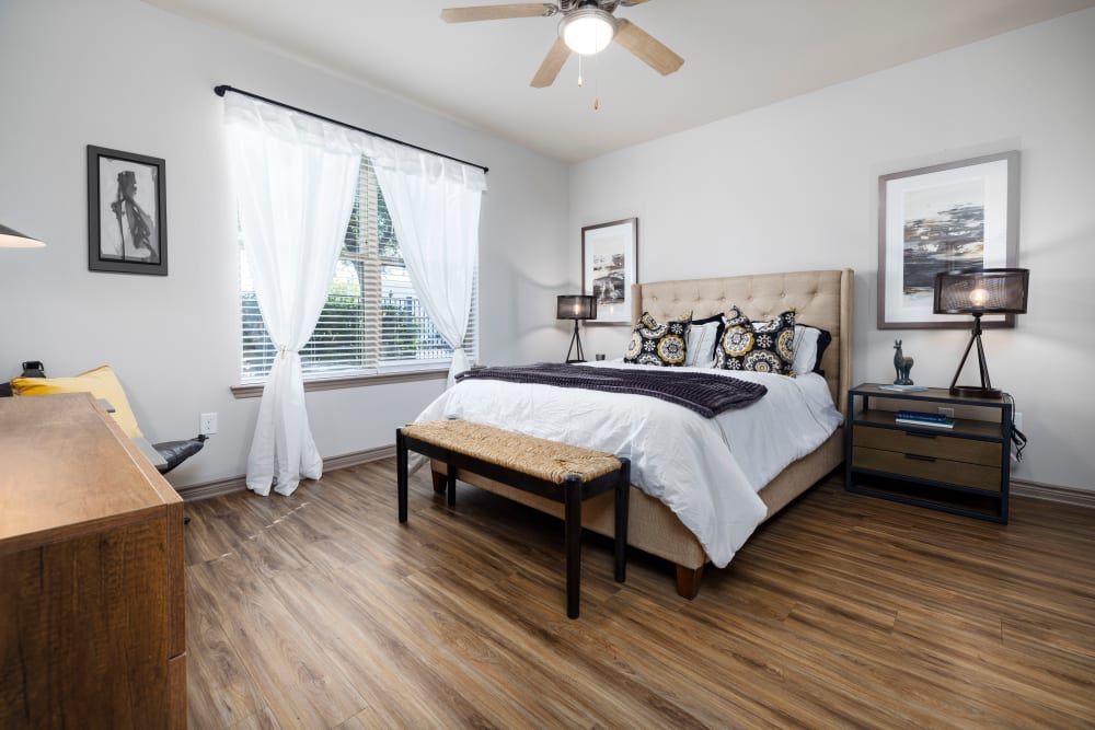 Primary bedroom with an en suite bathroom in a model home at Anatole on Briarwood in Midland, Texas