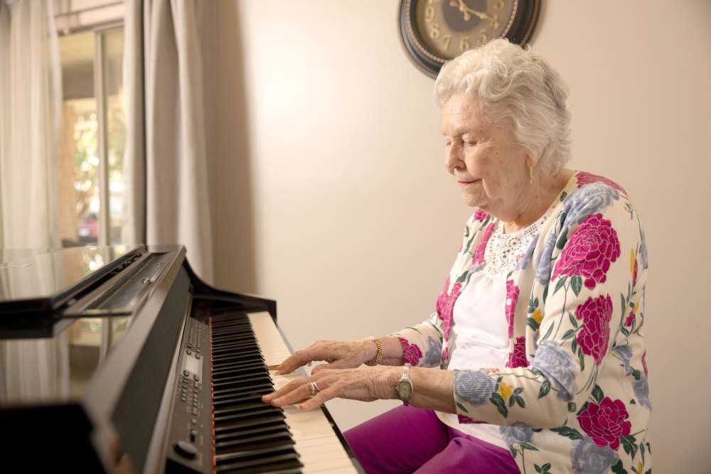 Resident playing piano at Glenncrest at Decatur in Decatur, Georgia