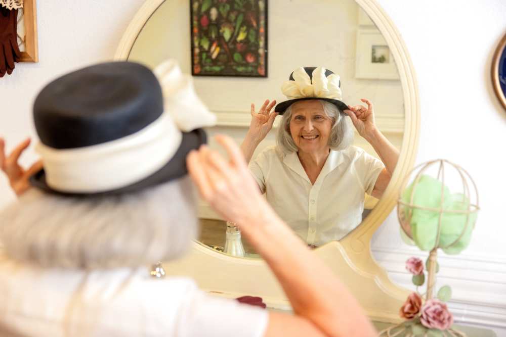 Resident looking at herself in the mirror at Glenncrest at Johns Creek in Johns Creek, Georgia