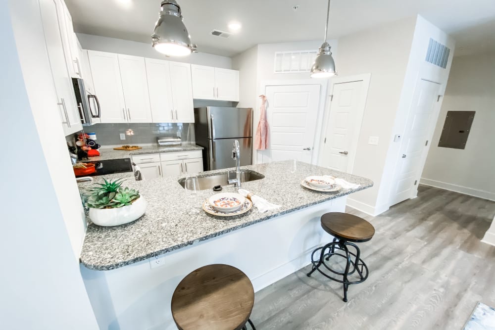 Model kitchen with breakfast bar at South City Apartments in Summerville, South Carolina
