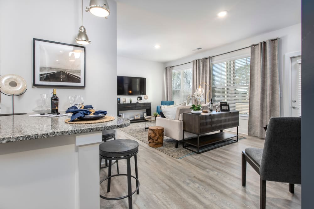 Model living room and breakfast bar at South City Apartments in Summerville, South Carolina
