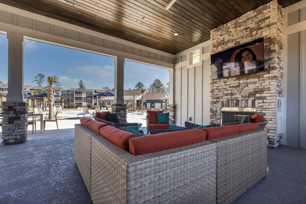 Outdoor lounge seating with TV at South City Apartments in Summerville, South Carolina