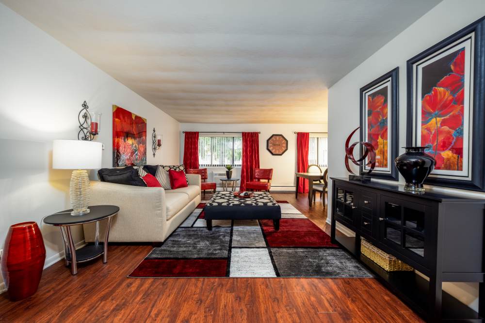 Living room with a couch and a coffee table at Greece Commons Apartments in Rochester, New York