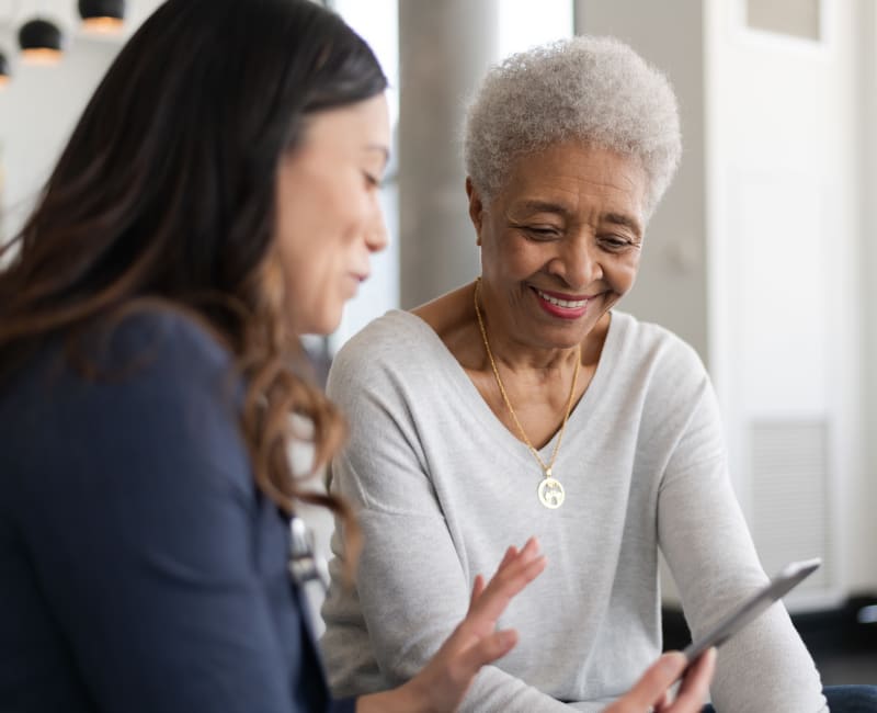 Resident talking to a caretaker about medication at York Gardens in Edina, Minnesota