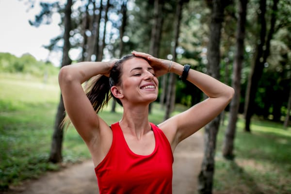 A woman with her hands on her head after a run through a park near Retreat at Fairhope Village in Fairhope, Alabama