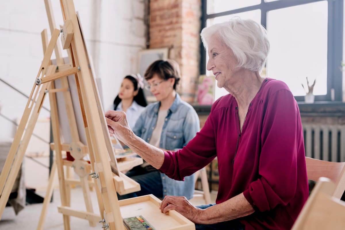 Residents painting in an art studio at Worthington Manor in Conroe, Texas