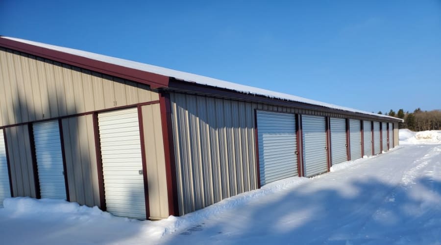 Storage units with white doors and locks at KO Storage of Cass County in Pillager, Minnesota