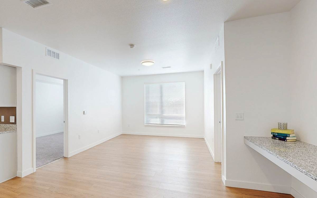 Unfurnished living room with attached desk at The Rose on Colfax in Denver,Colorado