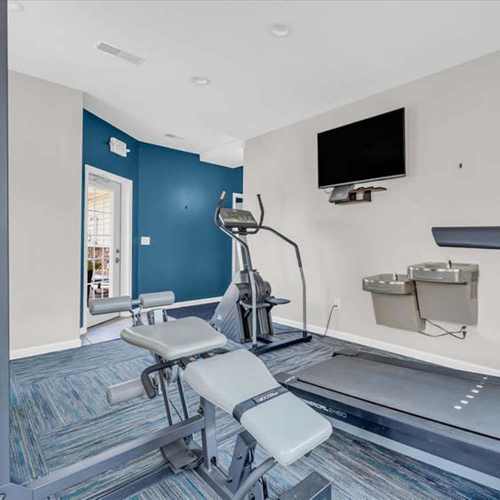 Modern fitness room featuring a treadmill at The Haven at Grand Landing Apartments in Grand Haven, Michigan