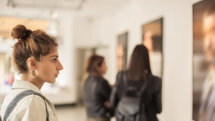 Resident admiring some artwork in a museum near The Davis in Fort Worth, Texas