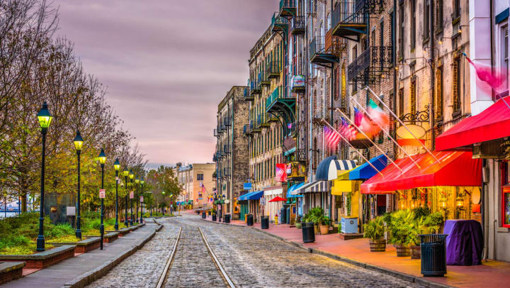 A beautiful cobblestoned street in the Savannah Historic District at dusk.