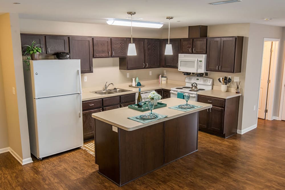 A spacious kitchen with beautiful wood-style cabinets at Silver Lake Hills in Fenton, Michigan