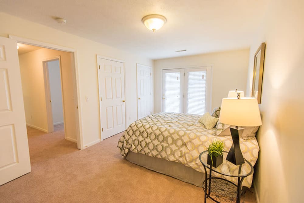 Spacious main bedroom with a large window for natural lighting at Silver Lake Hills in Fenton, Michigan