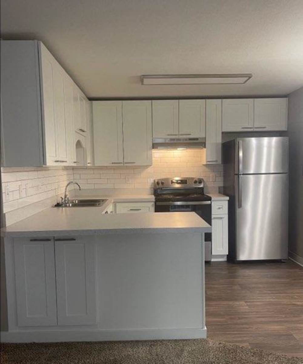 Fully equipped kitchen with stainless steel appliances at Amber Glen Apartments in Everett, Washington