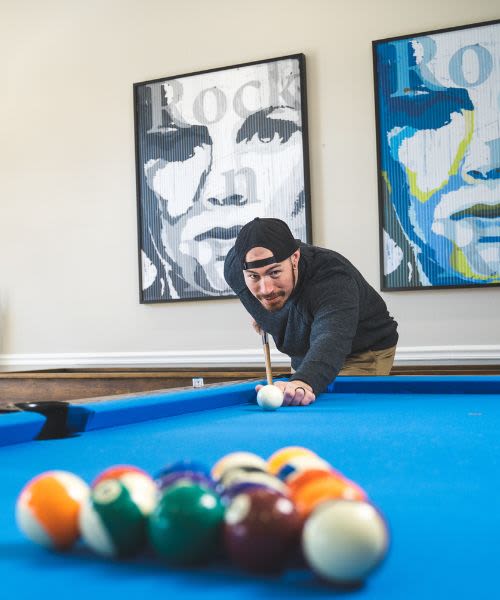 Resident playing billiards at a  Sequoia home