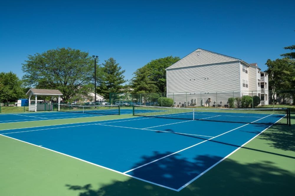 Two full-size tennis courts at Greenway Chase in Florissant, Missouri