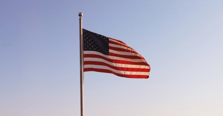 an American flag fluttering in the sunset