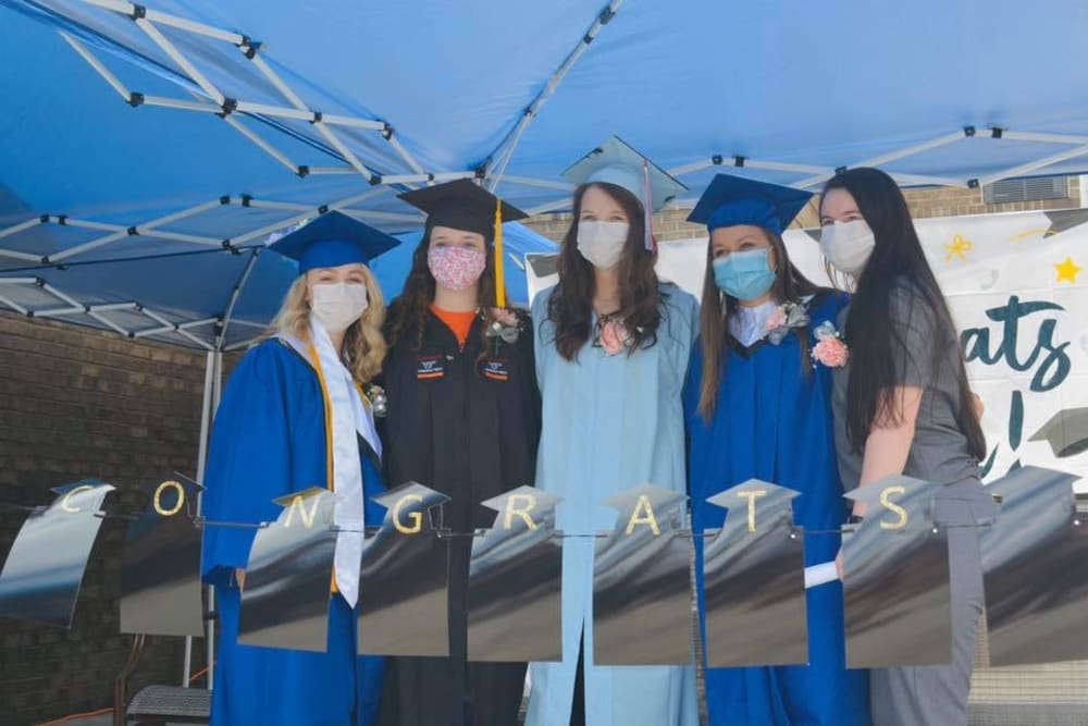 Group of staff members at a graduation ceremony at Lavender Hills Orange Campus in Orange, Virginia