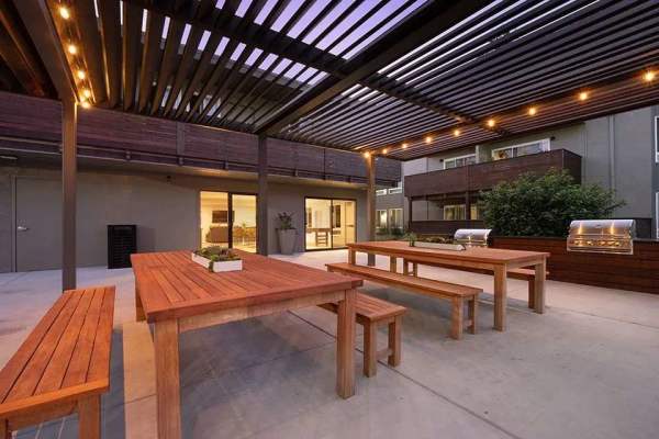 Outdoor seating with lighting at Polo Run Apartments in Stockton, California