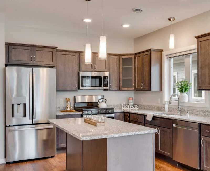 kitchen island with dark brown cabinets and gray countertops