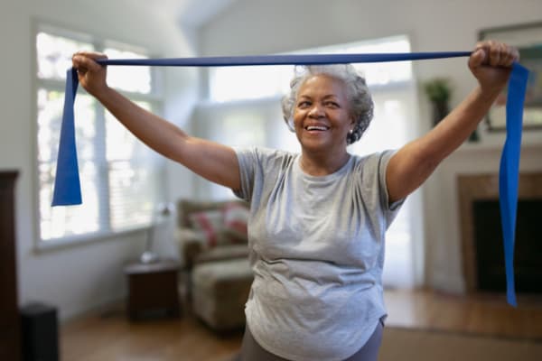 Laughing resident exercising at RockBrook Memory Care in Lewisville, Texas