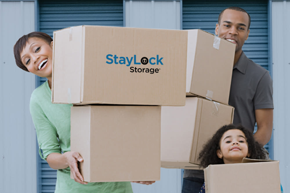 Family putting boxes into their new storage unit at StayLock Storage in Hebron, Indiana