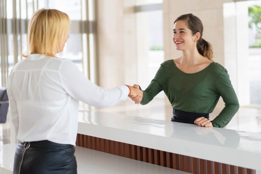 A women checking in at the front desk at I-5 Mini Storage in Wilsonville, Oregon
