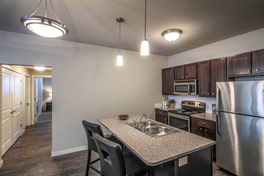 A kitchen with wood-style flooring at Traditions at Mid Rivers in Cottleville, Missouri at Traditions at Mid Rivers in Cottleville, Missouri