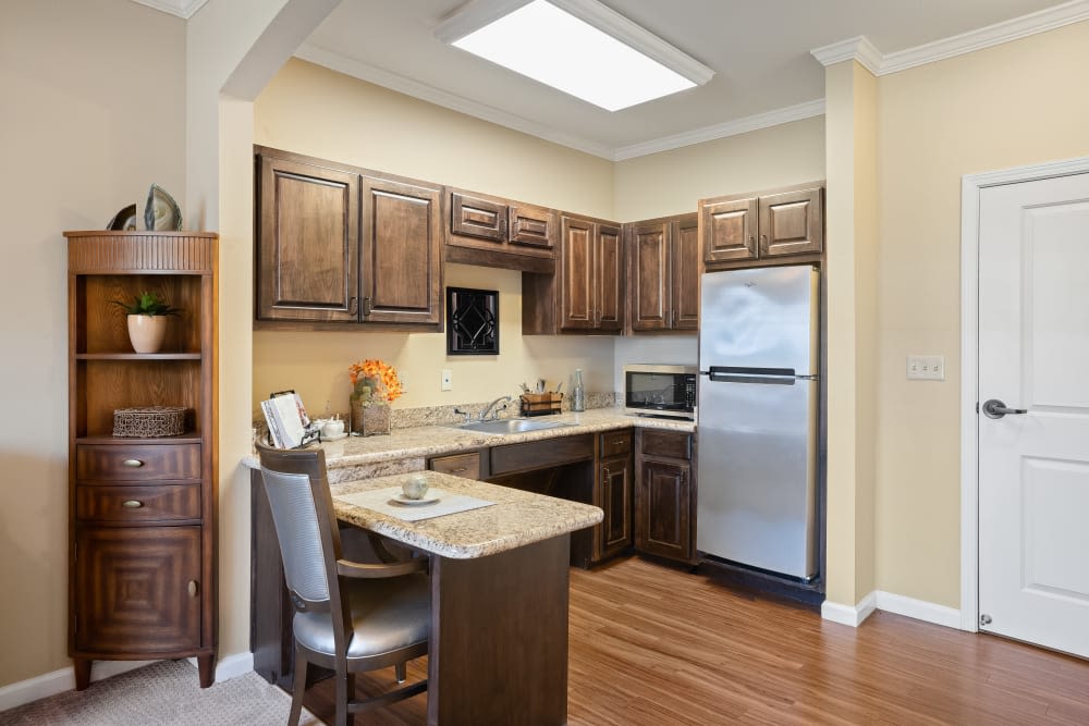Kitchen with hardwood floors in apartment at Anthology of Stonebridge Ranch in McKinney, Texas
