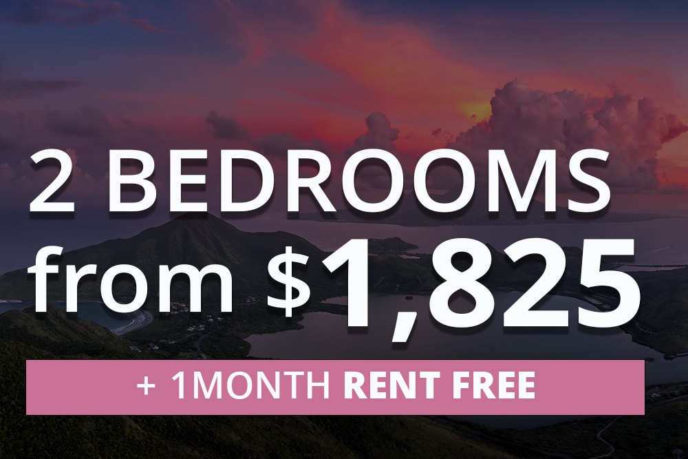Mountainous island at sunset with dramatic clouds and surrounding water. Overlaid text reads: '2 Bedrooms from $1,825' and '+ 1 Month Rent Free' in a pink banner.