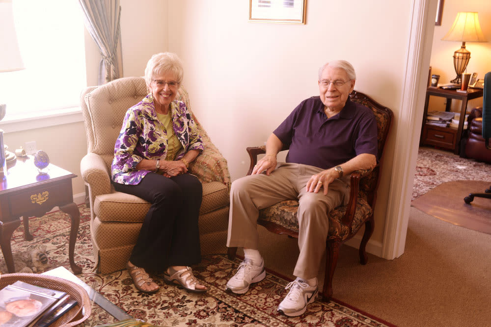 Resident couple sitting in recliner chairs at Quail Park at Browns Point in Tacoma, Washington