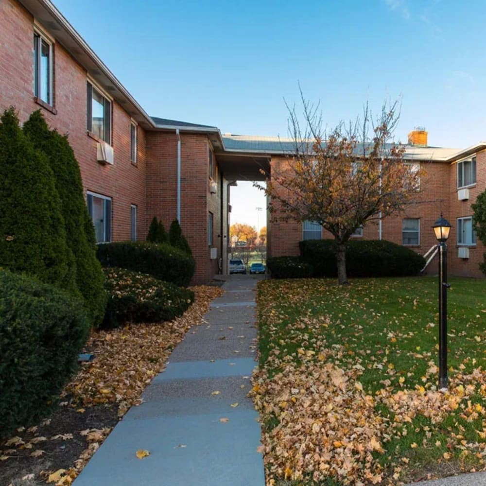 A path leading towards the apartments at Highland Bay Apartments in Rochester, New York