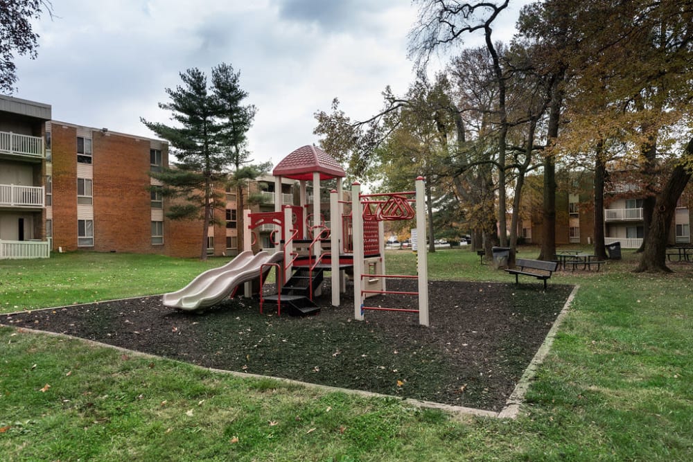 Children's playground surround by grass at The Glendale Residence in Lanham, Maryland
