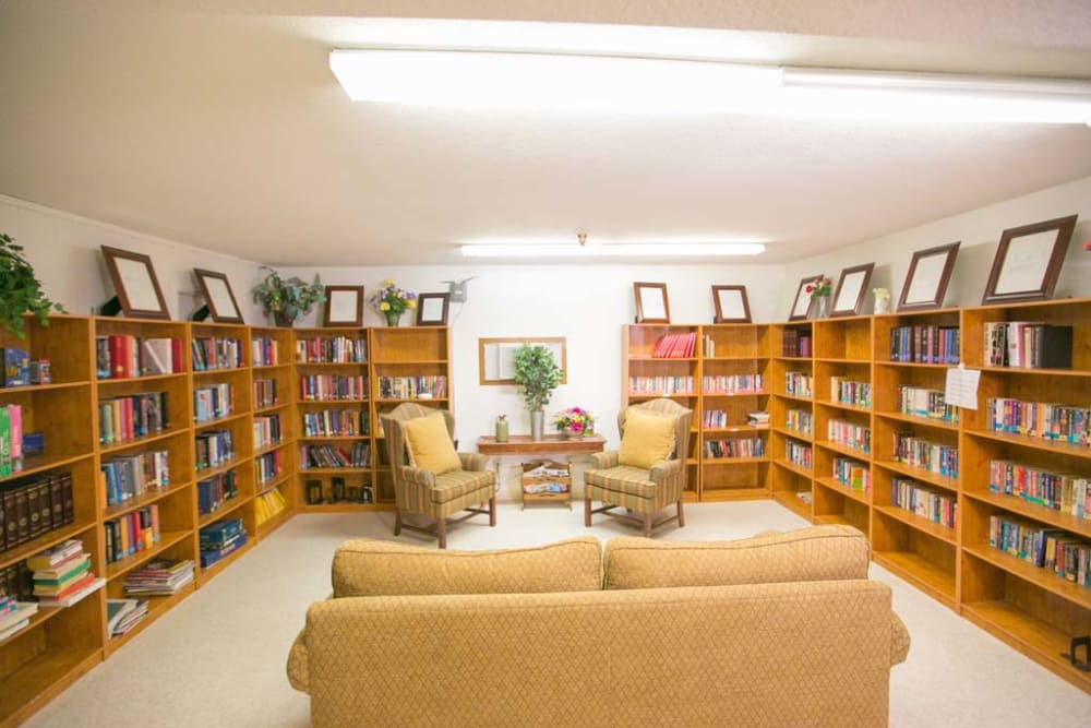 Elegant library with seating at Sherwood Village Assisted Living & Memory Care in Tucson, Arizona