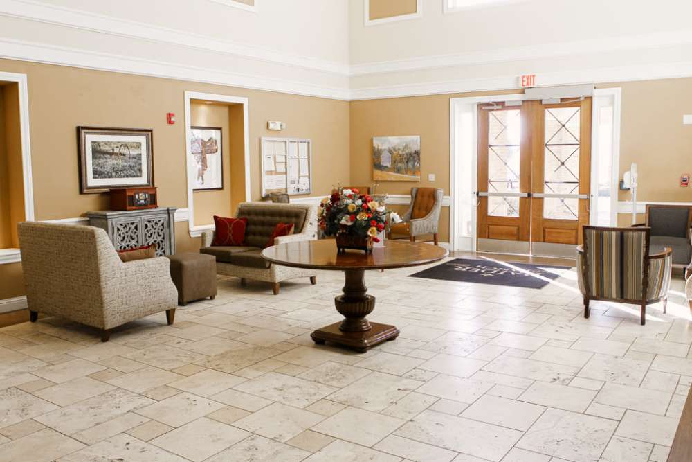 A room with large windows and plenty of seating at Isle at Raider Ranch in Lubbock, Texas