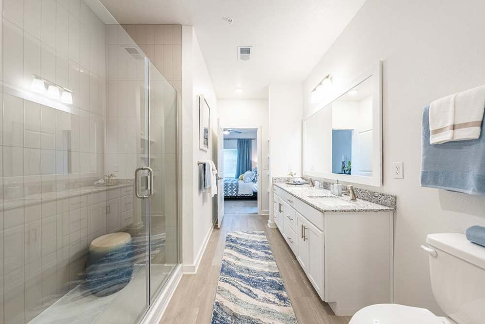 Primary bathroom with glass shower at Avion Apartments in Jacksonville, Florida