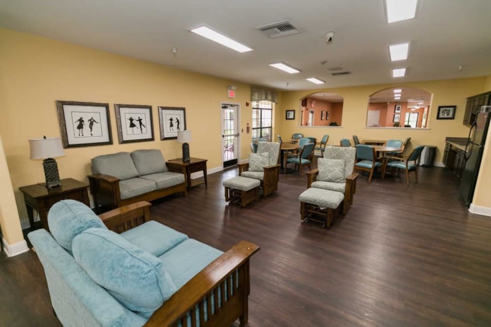 Elegant seating area with blue chairs at RockBrook Memory Care in Lewisville, Texas
