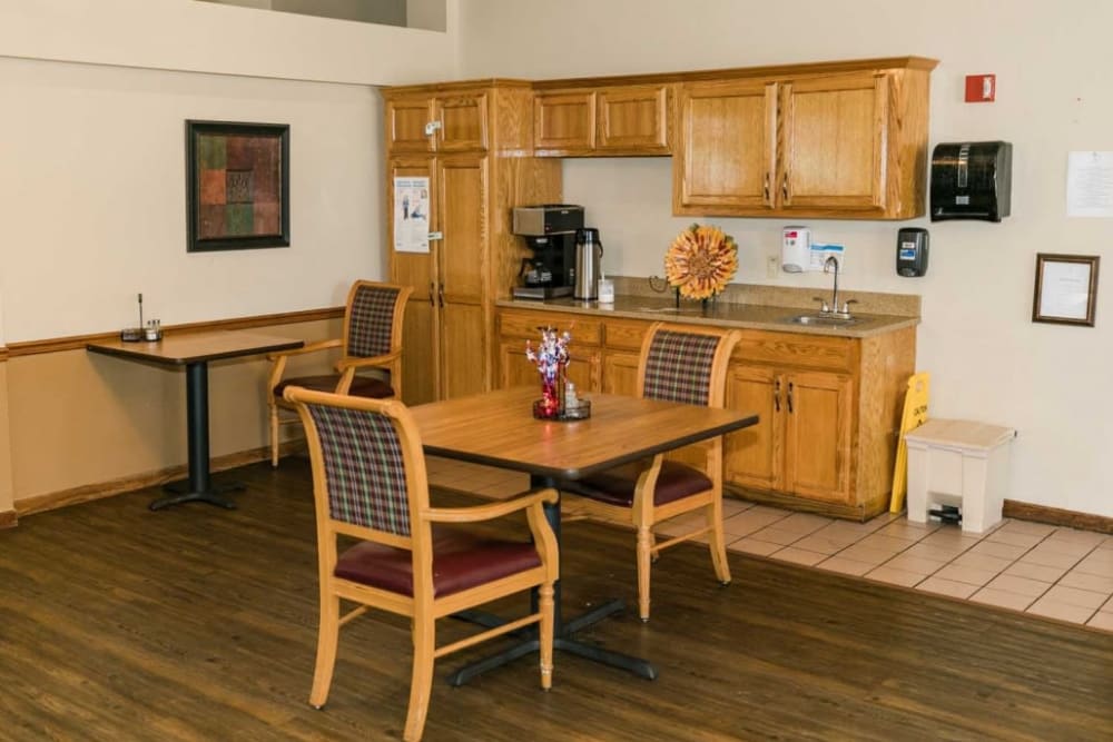 Dining room with wood table and cabinets at Meadow Creek Senior Living in Lancaster, Texas