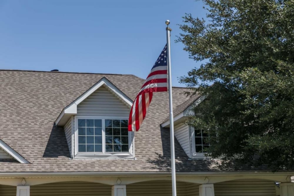 American flag and property at Deer Creek Senior Living in Desoto, Texas