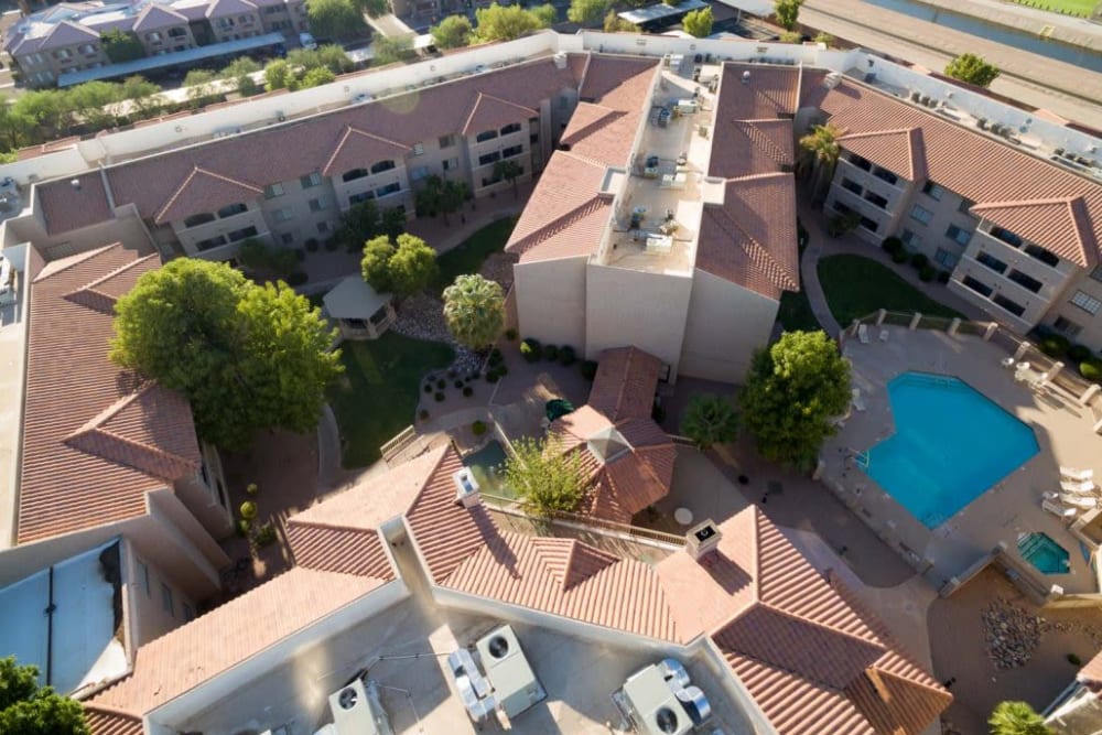 Exterior complete with pool at The Grand Court Senior Living in Mesa, Arizona