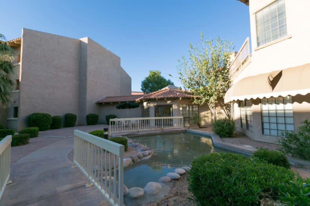 Exterior with beautiful pond at The Grand Court Senior Living in Mesa, Arizona
