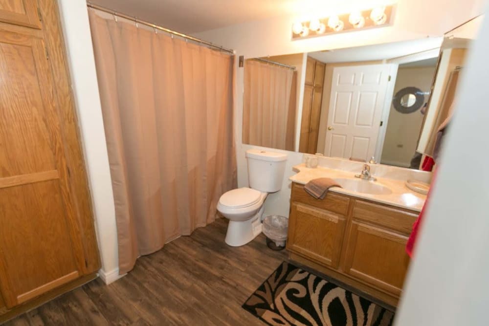 Wide and well lit bathroom in apartment at The Grand Court Senior Living in Mesa, Arizona