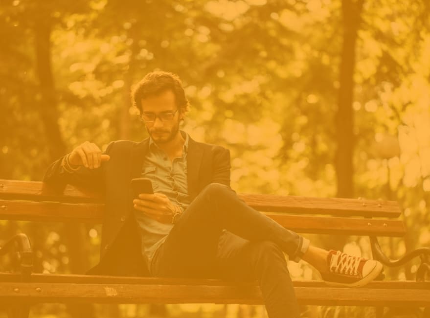 Resident relaxing on a bench in Irving Park near Amber Glen Apartments in Everett, Washington
