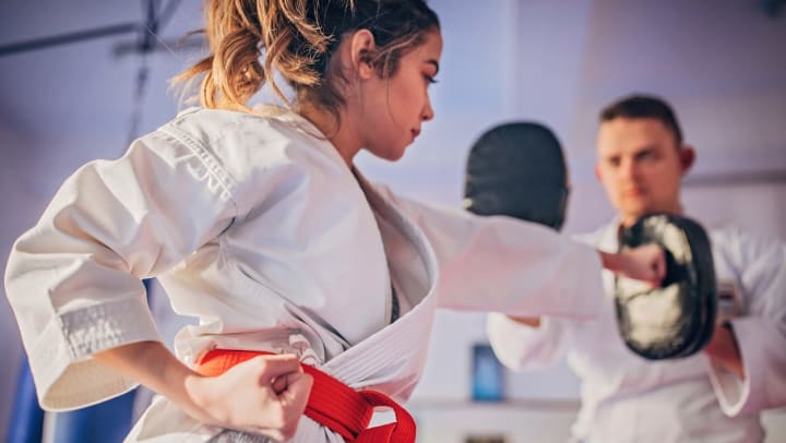 A woman training in karate sparring at a martial arts studios in Keller.