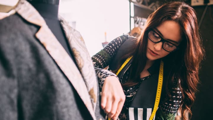 A female tailor in San Antonio making alterations to a men’s suit.