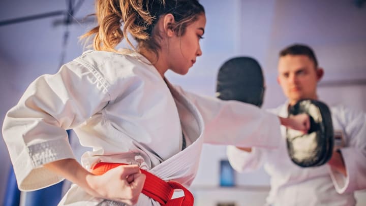 A martial arts student punching an instructors hand | Charlotte Martial Arts Schools